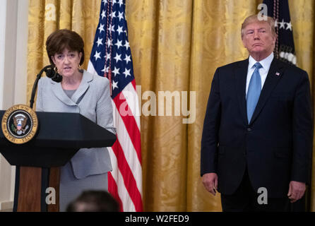 Chair of the Council on Environmental Quality Mary Neumayr, left, makes remarks on “America's Environmental Leadership” as United States President Donald J. Trump, right, listens in the East Room of the White House in Washington, DC on Monday, July 8, 2019.Credit: Ron Sachs/CNP | usage worldwide Stock Photo