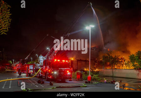 Modesto, CA, USA. 8th July, 2019. Modesto Fire Department responded to a working structure fire at the corner of Tully Road and 9th Street Tuesday, July 7, 2019 at 9pm. The fire quickly went to multiple alarms bring 3 fire ladder truck along with multiple other engines from throughout Stanislaus County. Credit: Marty Bicek/ZUMA Wire/Alamy Live News Stock Photo