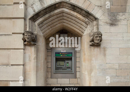 ATM cashpoint in a sandstone arch - old and new Stock Photo