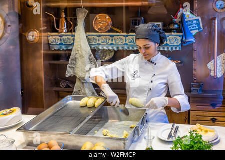 Porto, Portugal - November 15, 2017: The unidentified staff is preparing codfish cake in Casa Portuguesa do Pastel de Bacalhau, a famous restaurant in Stock Photo