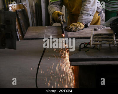 a worker cutting a Steel plate with oxy acetylene Stock Photo