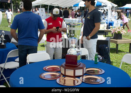 top view 2019 District Cup Polo trophy on table with blue cloth and chairs around table Stock Photo