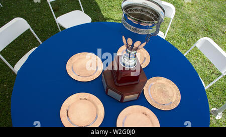 top view 2019 District Cup Polo trophy on table with blue cloth and chairs around table Stock Photo