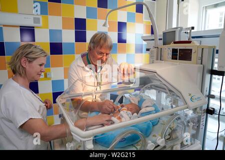 Doctor and nurse examining a newborn in an incubator, intensive care unit for newborns, Karlovy Vary, Czech Republic Stock Photo