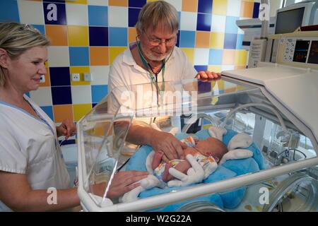 Doctor and nurse examining a newborn in an incubator, intensive care unit for newborns, Karlovy Vary, Czech Republic Stock Photo