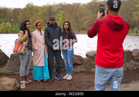 Meriden, CT USA. Apr 2019. Daffodil Festival. Indian American family posing for photographs. Stock Photo