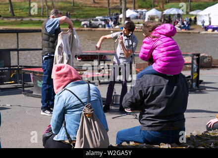 Meriden, CT USA. Apr 2019. Daffodil Festival. A focused young girl enjoying the straight jacket performance. Stock Photo