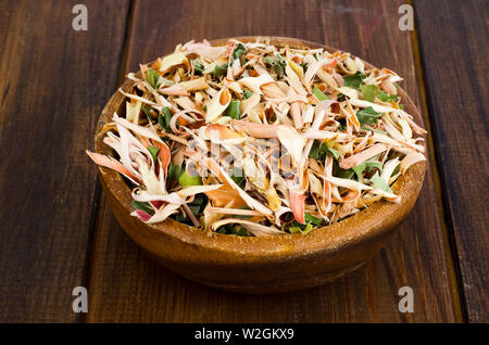 Dried lemongrass leaves in wooden bowl.  Stock Photo