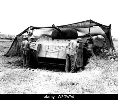 Fifth Army. Anzio Area, Italy. Dummy tank designed by British, made of rubber and inflated when used. Can be assembled in 20 minutes. When used in field can simulate tank positions. General view showing soldiers [placing] the completely assembled dummy [tank] into a camouflaged position [illeg.] recently vacated by a medium [tank] [illeg.] moving up to attack Stock Photo