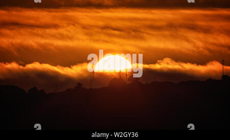 A telephoto color image of the sun setting over Trinidad Head, California, USA. Stock Photo