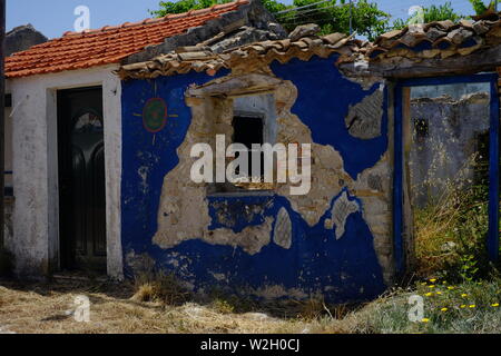 Artistic designed blue graffiti on an old/new house situated in Afionis Corfu Stock Photo