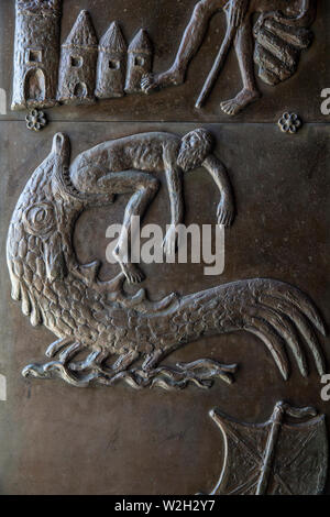 Relief on a door of the Annunciation Roman catholic basilica, Nazareth, Galilee, Israel. Jonah and the whale. Stock Photo