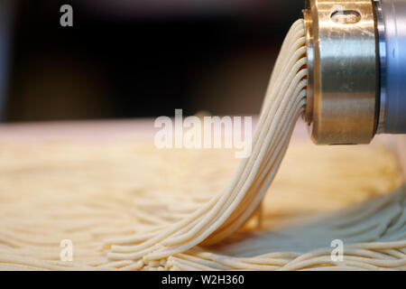 Fresh pasta making in machine.  Venice. Italy. Stock Photo