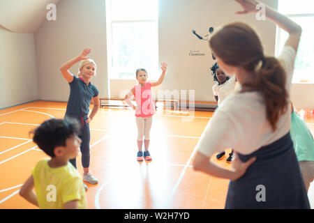 Classmates training together at their sports lesson. Stock Photo