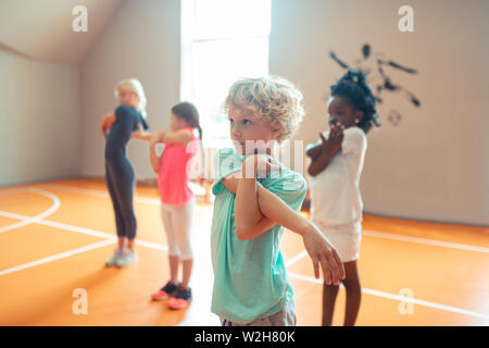 Concentrated school children at their sports lesson. Stock Photo