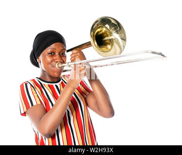 black teen girl with headscarf and musical instrument trombone against white background Stock Photo