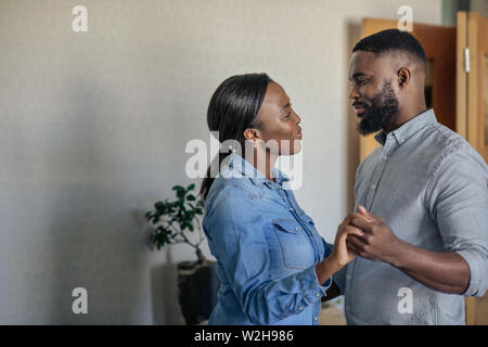 Affectionate young African American couple dancing together at home Stock Photo