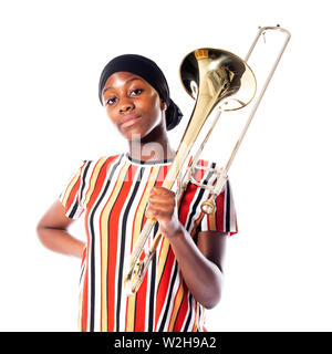 black teen girl with headscarf and musical instrument trombone against white background Stock Photo