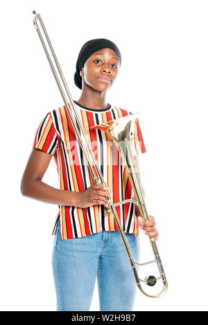 black teen girl with headscarf and musical instrument trombone against white background Stock Photo