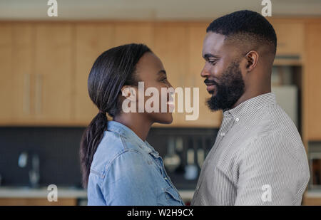 Loving young African American couple looking into each other's eyes Stock Photo