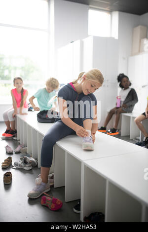Glad children sitting on a bench at the playground Stock Photo - Alamy