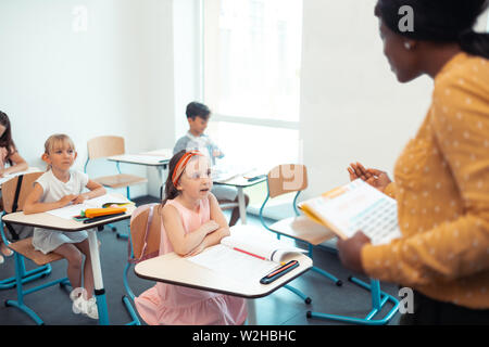 Teacher wearing yellow blouse teaching smart cute pupils Stock Photo