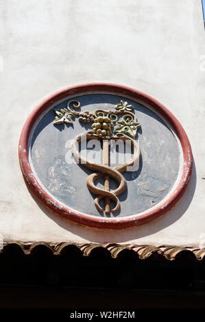 Symbol of the Greek God Aesculapius, on an Italian building in Kos Town,  Kos Island, Dodecanese Islands, Greece. Stock Photo