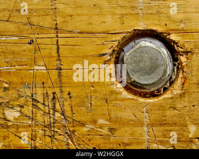 A wooden workbench with rough plank surface, power cord, and hand ...
