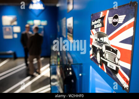 Bonn, Germany. 09th July, 2019. A sign with advertising for mini automobiles hangs on a wall. The exhibition 'Very British' at the Haus der Geschichte deals with the German-British relationship since 1945. Credit: Federico Gambarini/dpa/Alamy Live News Stock Photo