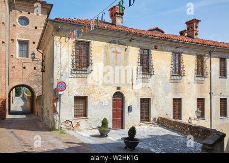MONDOVI, ITALY - AUGUST 18, 2016: Old building with fresco with cross in a sunny summer day, blue sky in Mondovi, Italy. Stock Photo