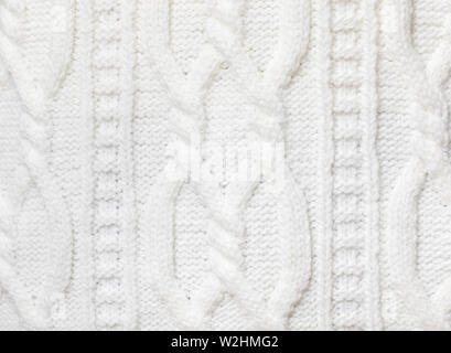 Real white knitted fabric with  cable pattern textured background Stock Photo