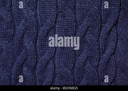 Real blue knitted fabric with  cable pattern textured background Stock Photo