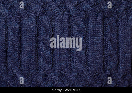 Real blue knitted fabric with  cable pattern textured background Stock Photo