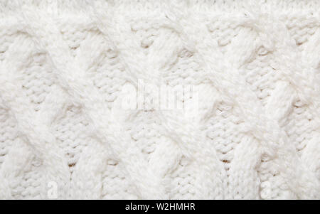 Real white knitted fabric with  cable pattern textured background Stock Photo