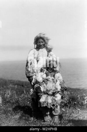 Edward S. Curtis Native American Indians -  Eskimo adult and child wearing duck-skin parkas ca. 1929 Stock Photo