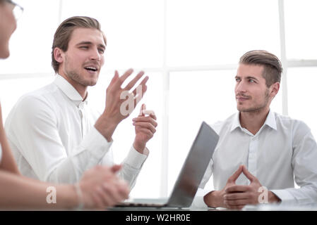 business colleagues sitting at the Desk. Stock Photo