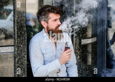 habits concept. man smoking e-cigarette. hipster man hold vaping device.  Mature hipster with beard. Health safety and addiction. inhaling vapor.  Bearded brutal male smoking electronic cigarette Stock Photo - Alamy