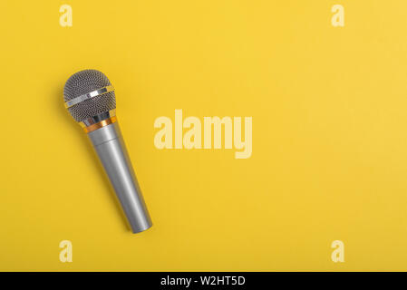 Concert microphone on beautiful yellow background. Stock Photo