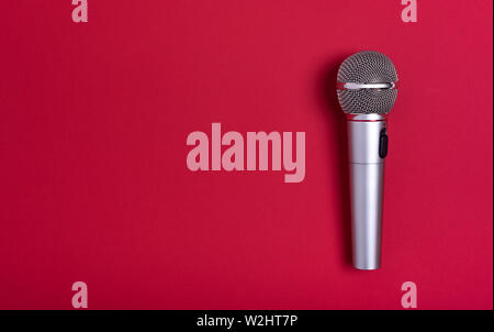 Concert microphone on beautiful red background. Stock Photo