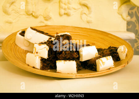 Cut pieces of iced cake on wooden bowl for 50th wedding anniversary party Stock Photo