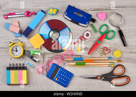 Assortment of school items on wooden background. Stock Photo