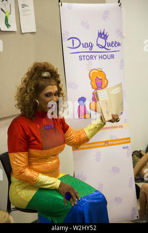 Drag Queen Story Hour, a national organization runs programs intended to instill a love of reading in young kids and also seeks to spread messages about self-love, acceptance of others and appreciation of diversity: Parents & children listen to a story at the Crown Heights branch of the Brooklyn Public Library. Stock Photo