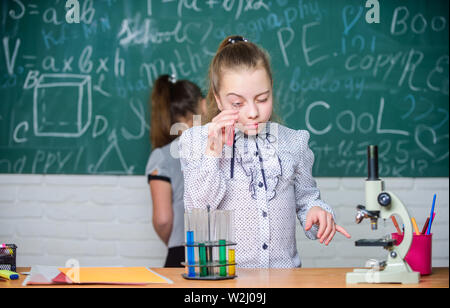 School classes. Biology and chemistry lessons. Observe chemical reactions. Chemical reaction much more exciting than theory. Girls working chemical experiment. Natural science. Educational experiment. Stock Photo