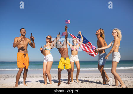 Group of friends having fun together on the beach Stock Photo