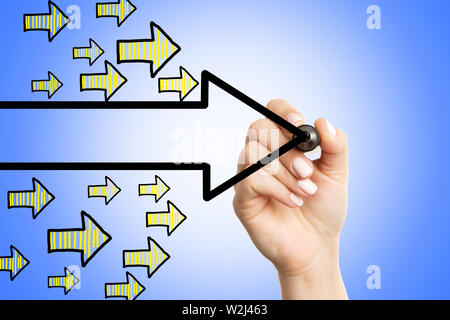 Closeup of female drawing black arrow on blue display as pointing direction concept Stock Photo