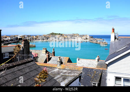 St. Ives, Cornwall, UK. June 30, 2019. The seaside town and harbor taken over the rooftops at St. Ives in Cornwall, UK. Stock Photo