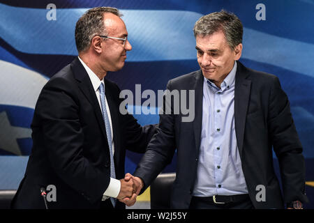 Athen, Greece. 09th July, 2019. The new Greek Finance Minister Christos Staikouras (l) and his predecessor Euclid Tsakalotos shake hands at the handover in the Ministry of Finance. Credit: Angelos Tzortzinis/dpa/Alamy Live News Stock Photo
