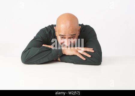 Depressed Indian businessman with his face down Stock Photo