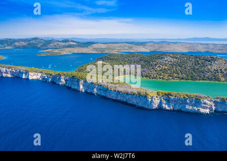 Aerial view of the Salty green lake in nature park Telascica, Croatia, Dugi otok, big stone cliffs above the sea Stock Photo