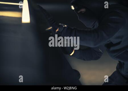 Car Stealing Concept. Caucasian Vehicle Thief in Action. Stock Photo